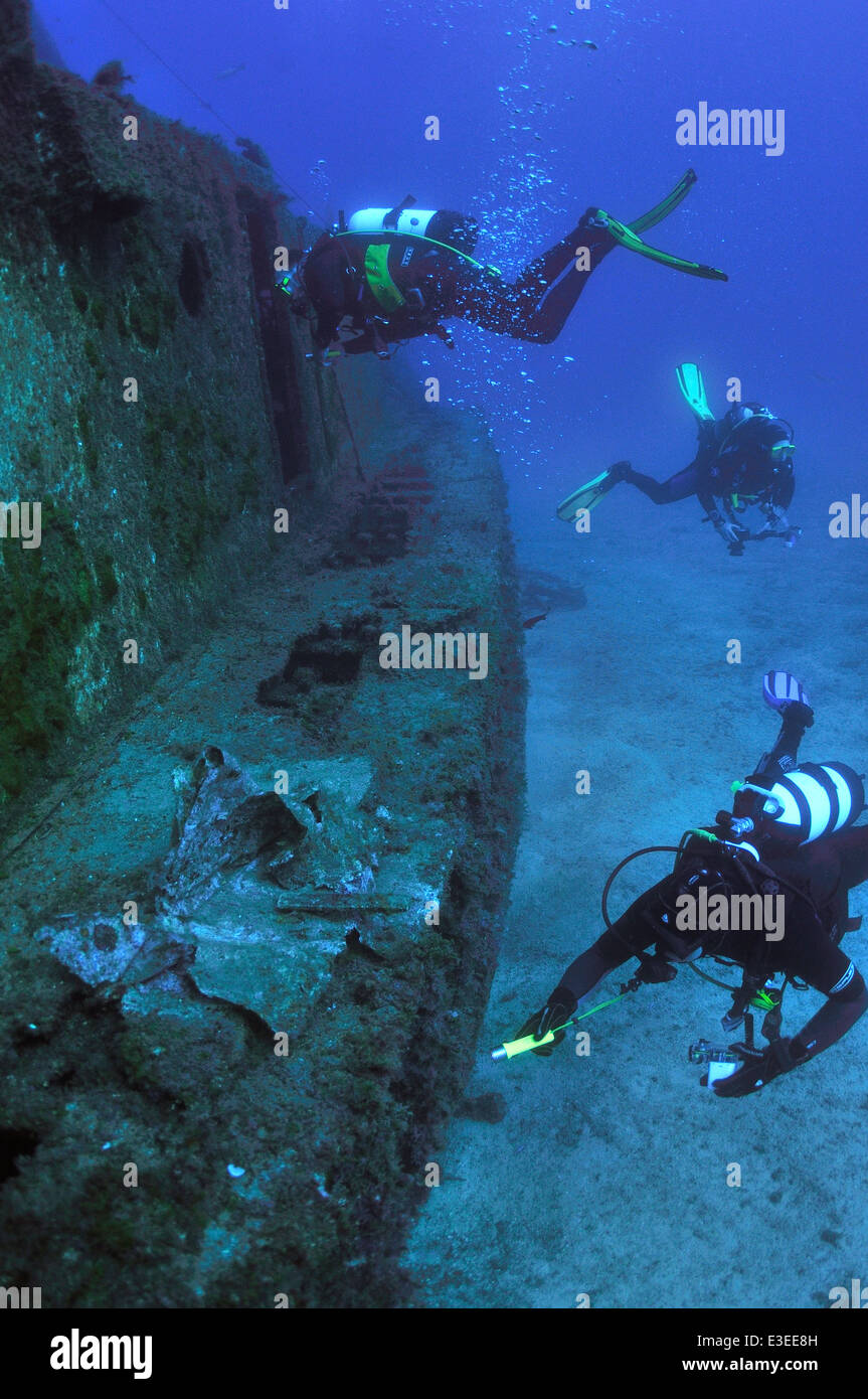 Scuba divers underwater alongside the El Meridian wreck south Tenerife, Canary Islands Stock Photo