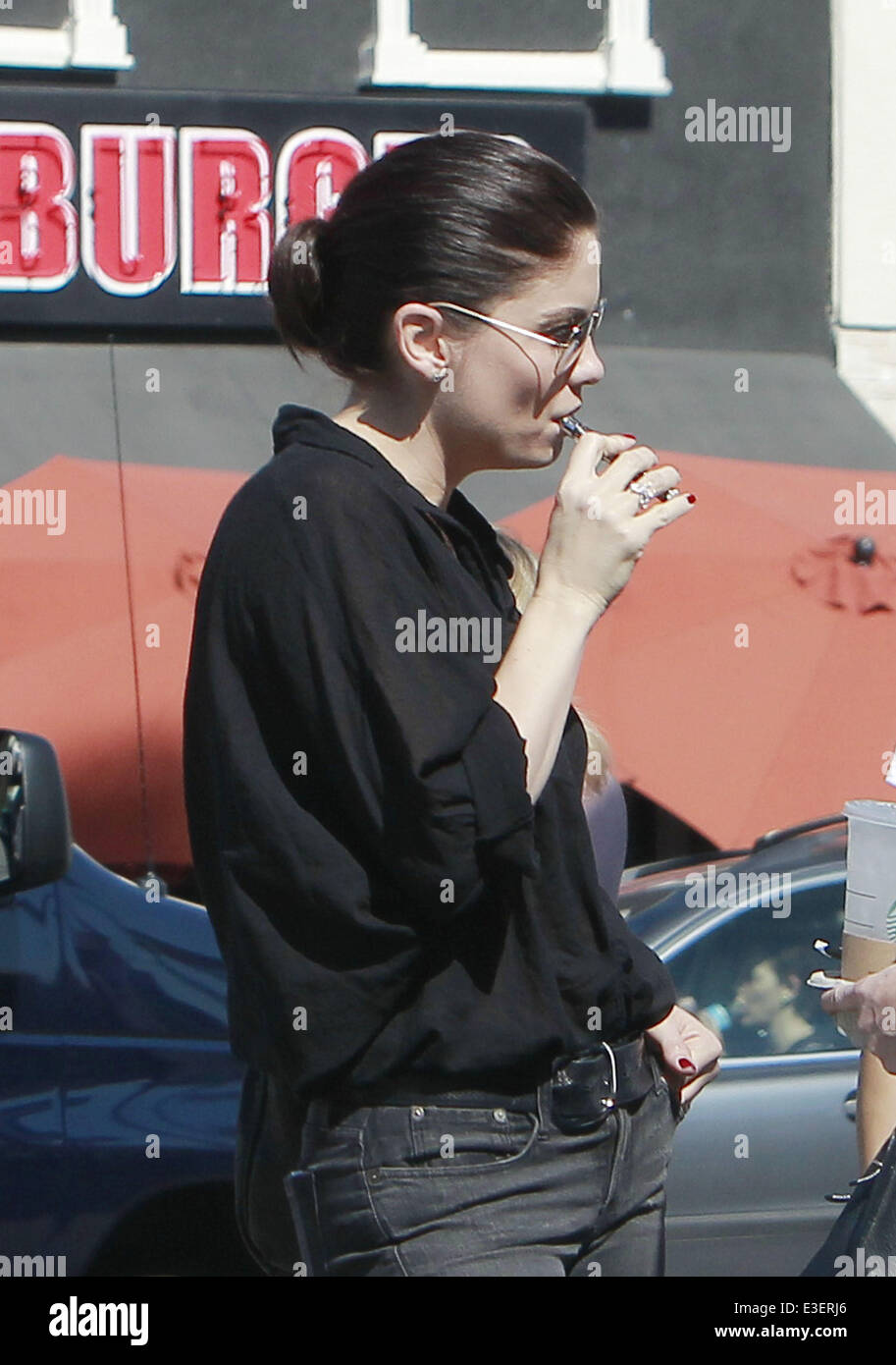 Nash Bridges Actress Jodi Lyn O’Keefe smokes a Vaporizer while wearing a see-thru shirt in West Hollywood  Featuring: Jodi Lyn O'Keefe Where: Los Angeles, CA, United States When: 22 Oct 2013 Stock Photo