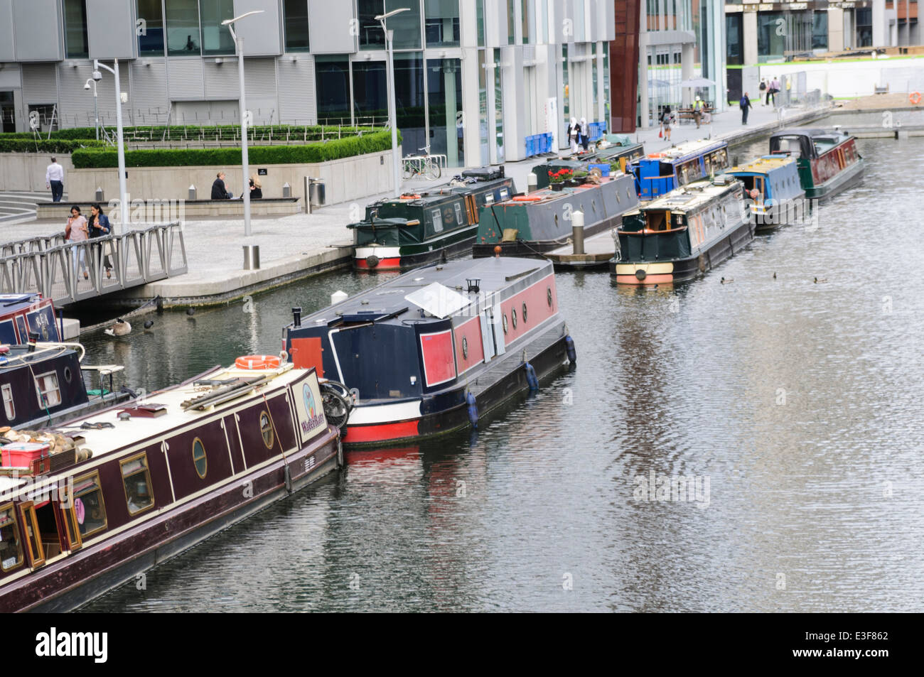 Canal boats moored at Paddington Basin, alongside tall office buildings. Stock Photo