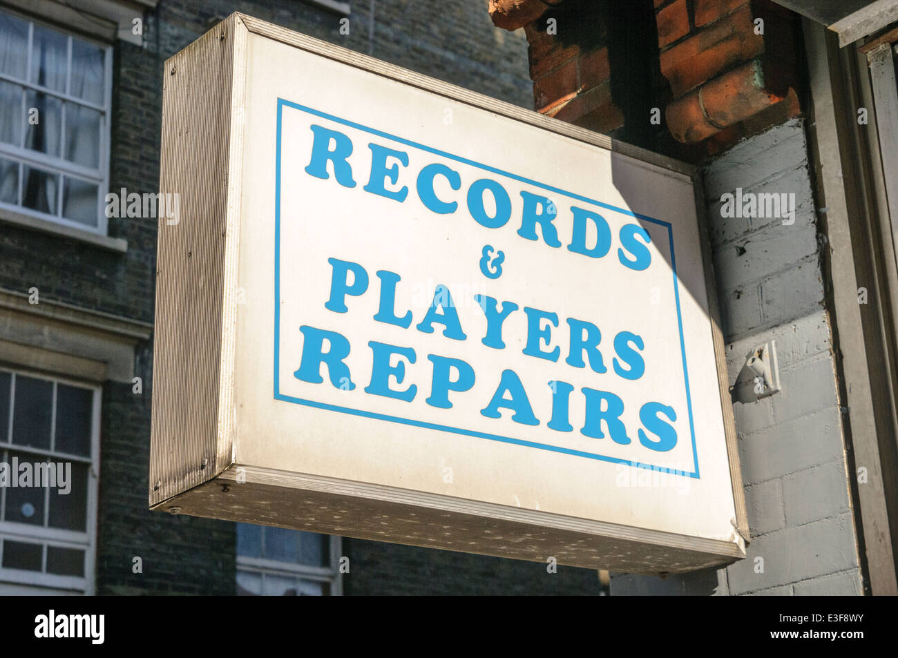 Sign at a shop offering Records and player repairs. Stock Photo