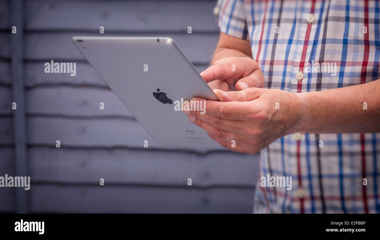 Person Using a Apple Ipad Tablet. Stock Photo