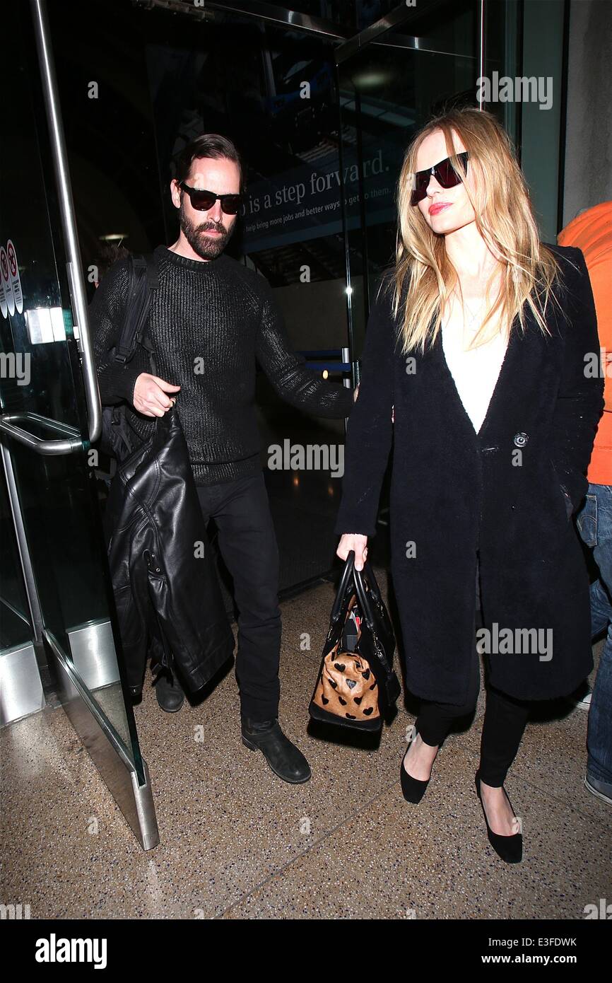Kate Bosworth and husband Michael Polish hold hands as they arrive at