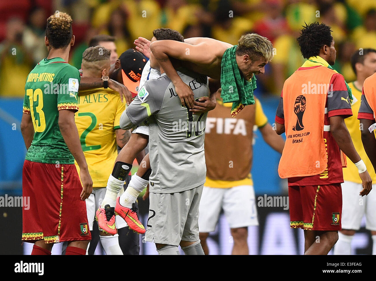 Brasilia, Brazil. 23rd June, 2014. Brazil's Neymar celebrates with goal keeper Julio Cesar (C) next to Cameroon's Eric Choupo Moting (L) after the FIFA World Cup 2014 group A preliminary round match between Cameroon and Brazil at the Estadio Nacional in Brasilia, Brazil, 23 June 2014. Photo: Marius Becker/dpa/Alamy Live News Stock Photo