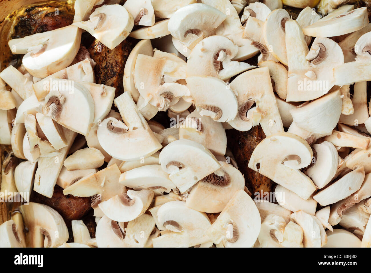 Food. Closeup of roasted chicken meat with champignons mushrooms as background. Cooking and traditional cuisine. Stock Photo