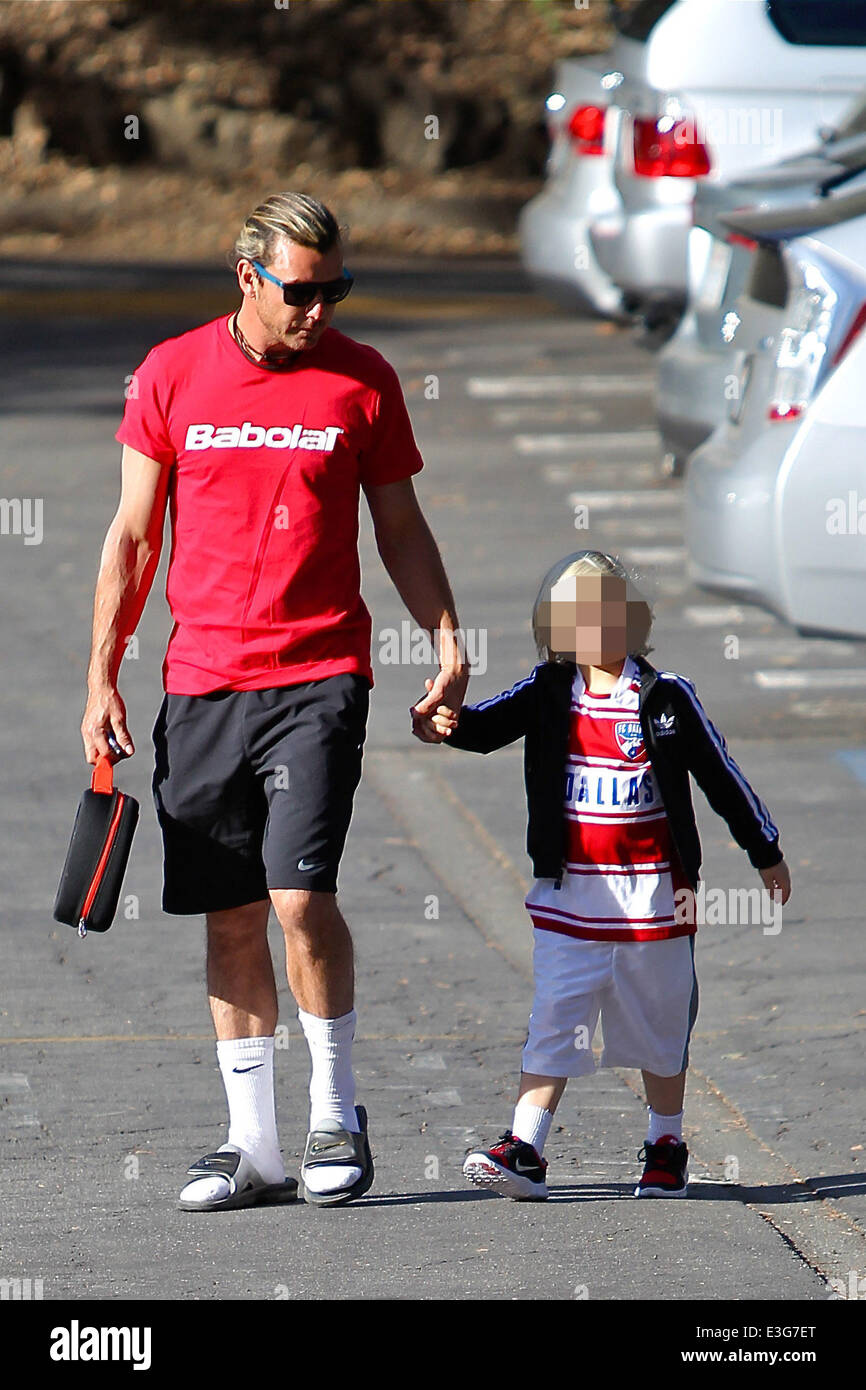 Gavin Rossdale wearing a red french sportswear top from Babolat with Nike  shorts, white socks and sandals, takes son Zuma to school wearing adidas  tracksuit top and FC Dallas soccer shirt Featuring: