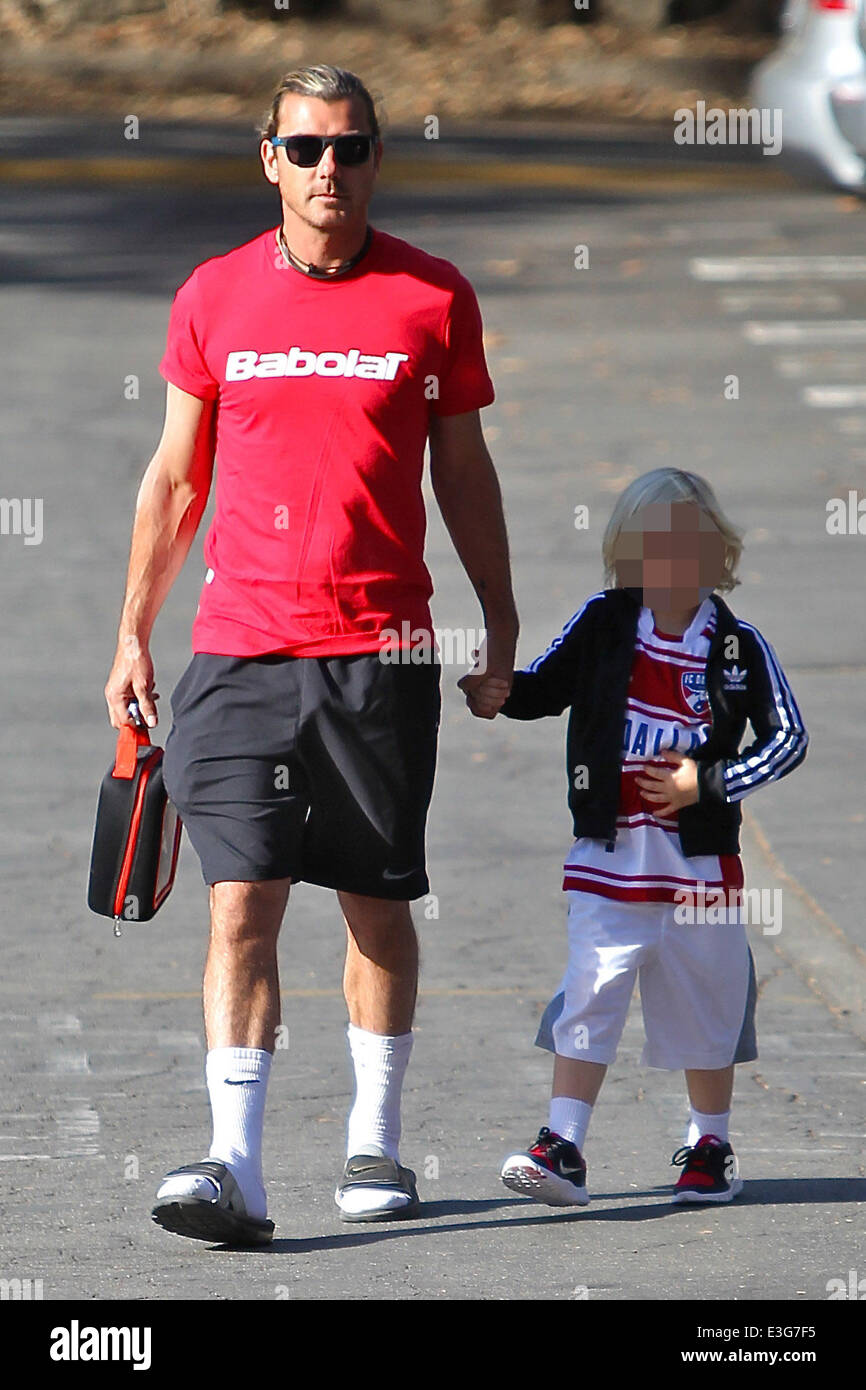 Gavin Rossdale wearing a red french sportswear top from Babolat with Nike  shorts, white socks and sandals, takes son Zuma to school wearing adidas  tracksuit top and FC Dallas soccer shirt Featuring: