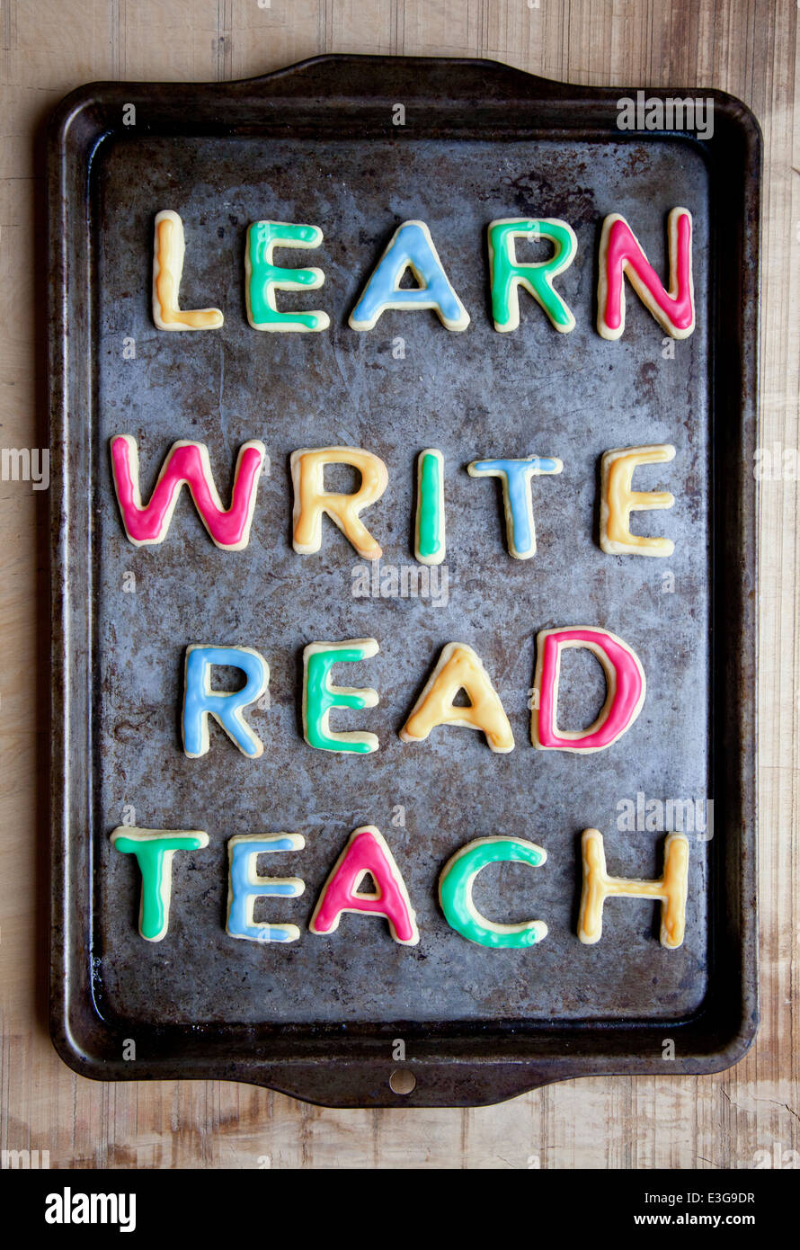Learn Write Read and Teach cookies on baking tray Stock Photo