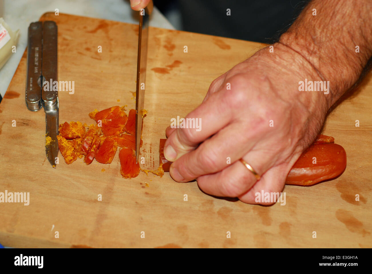 A man cutting and preparing botargo Stock Photo