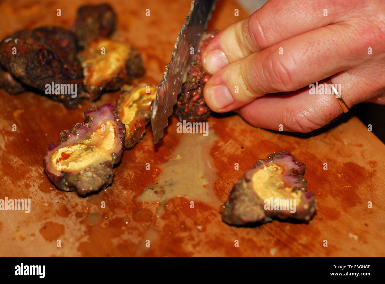 A person cutting and preparing sea violets (also called sea figs Stock ...