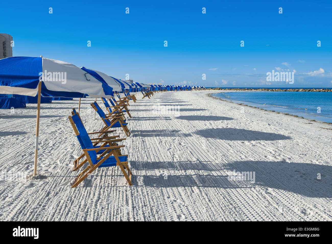 lots of sun loungers and beach umbrellas on silver sand, vacation concept Stock Photo