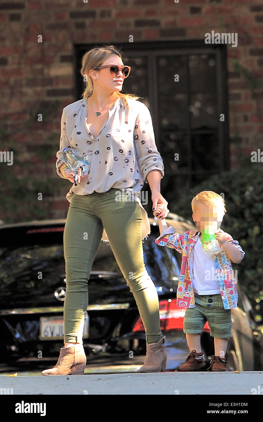 Hilary Duff seen out with son Luca in Beverly Hills. Luca stumbles and falls and Hilary comforts him with a kiss on the knee.  Featuring: Hillary Duff,Luca Comrie Where: Los Angeles, California, United States When: 14 Nov 2013 Stock Photo