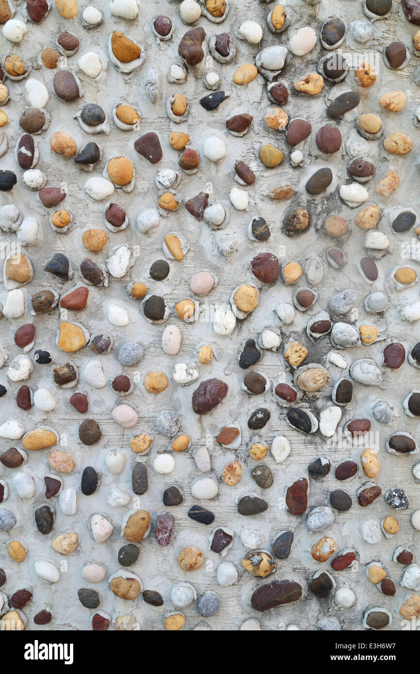 Pebbles in concrete wall texture background Stock Photo Alamy