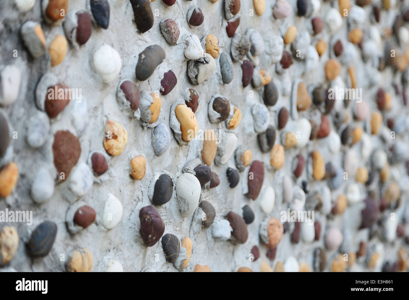 Pebbles in concrete wall texture background Stock Photo - Alamy - Concrete Wall Painting With Pebbles