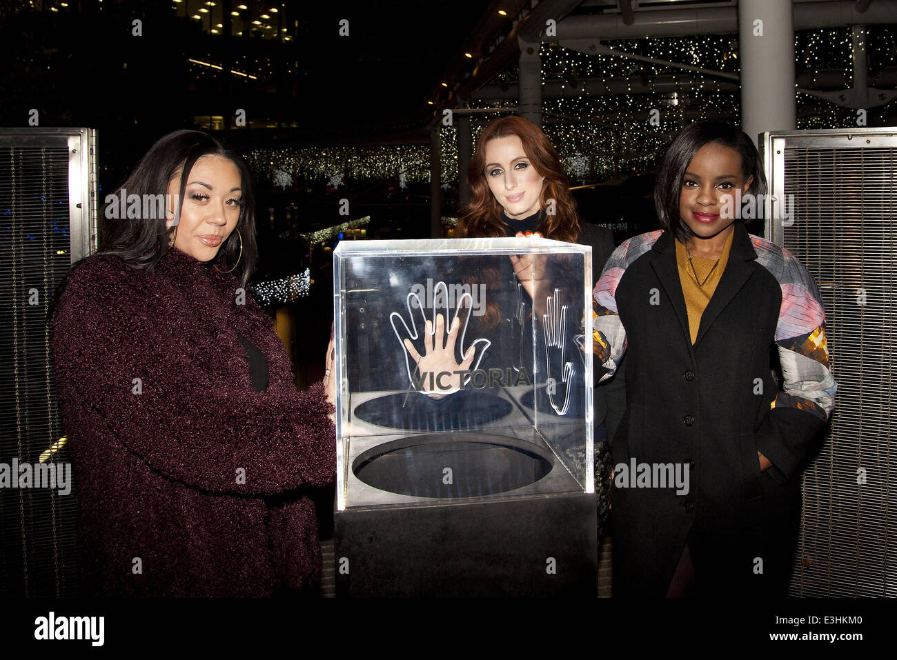 Mutya, Keisha, Siobhan (former and founding members of the Sugababes) perform live at the launch of the Create Christmas exhibition in the Cardinal Place shopping Centre in London's Victoria. The exhibition is made of giant photographs projected onto the Stock Photo