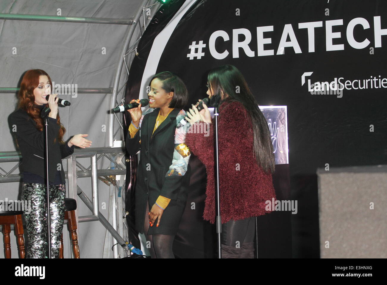Mutya, Keisha, Siobhan (former and founding members of the Sugababes) perform live at the launch of the Create Christmas exhibition in the Cardinal Place shopping Centre in London's Victoria. The exhibition is made of giant photographs projected onto the Stock Photo