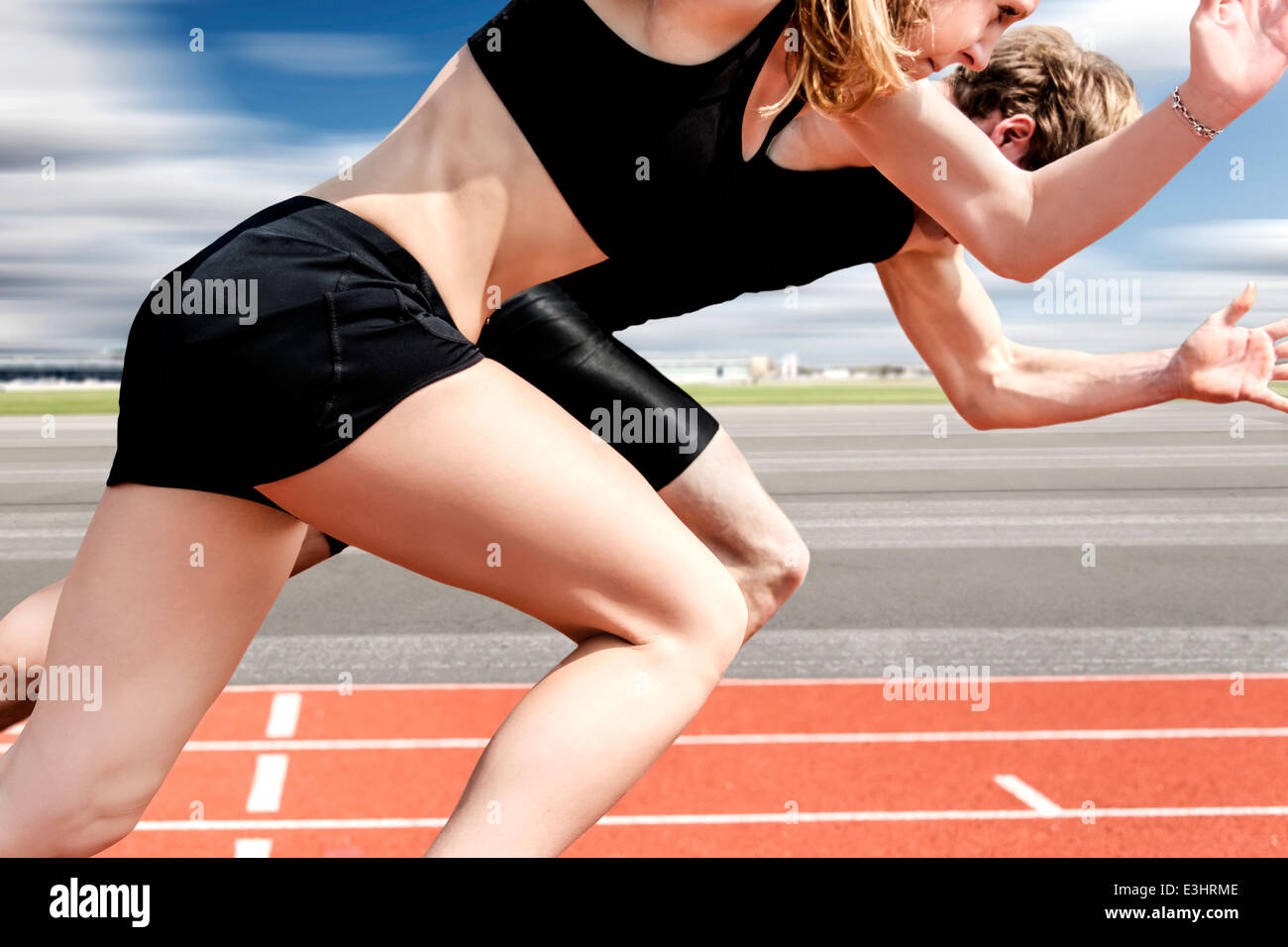 Race of male and female track and field athletes on airport runway Stock Photo