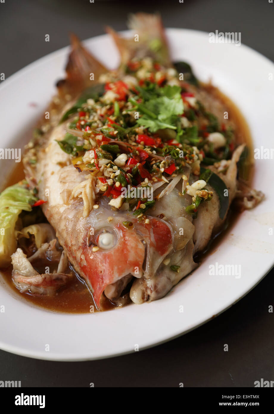 Steamed sea bass with lemon on plate Stock Photo Alamy