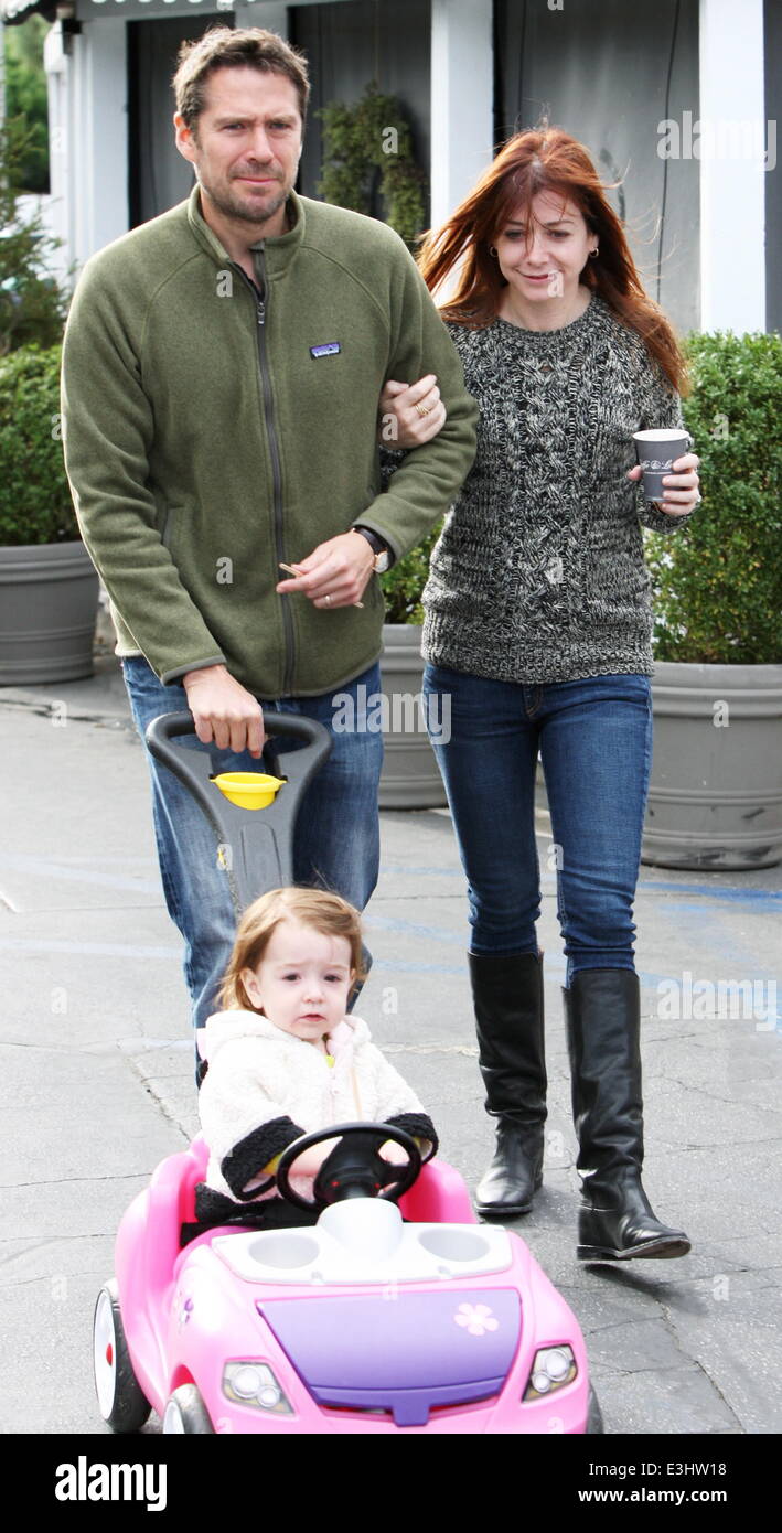 Alyson Hannigan and husband Alexis Denisof push their daughter Keeva in