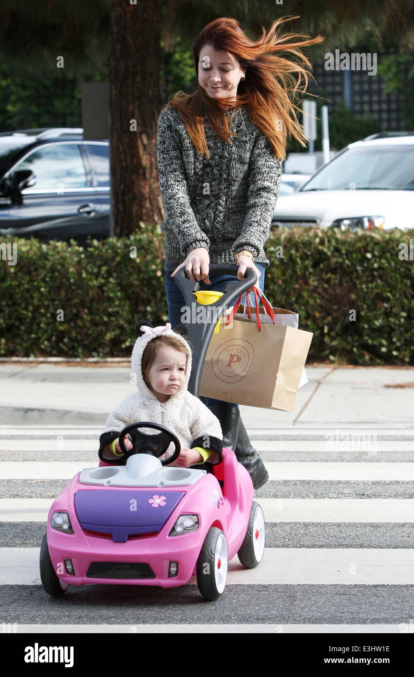 Alyson Hannigan and husband Alexis Denisof push their daughter Keeva in