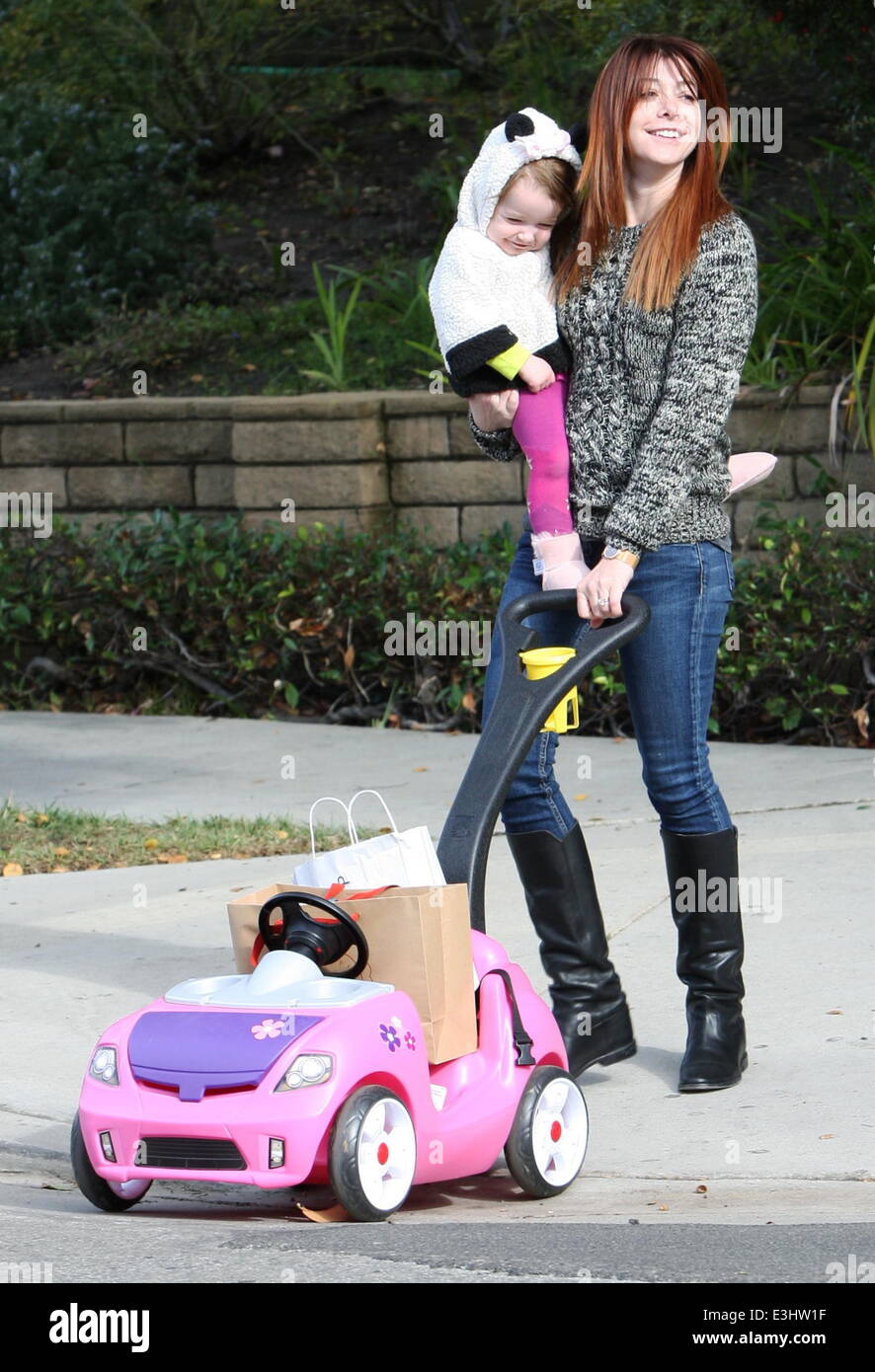 Alyson Hannigan and husband Alexis Denisof push their daughter Keeva in