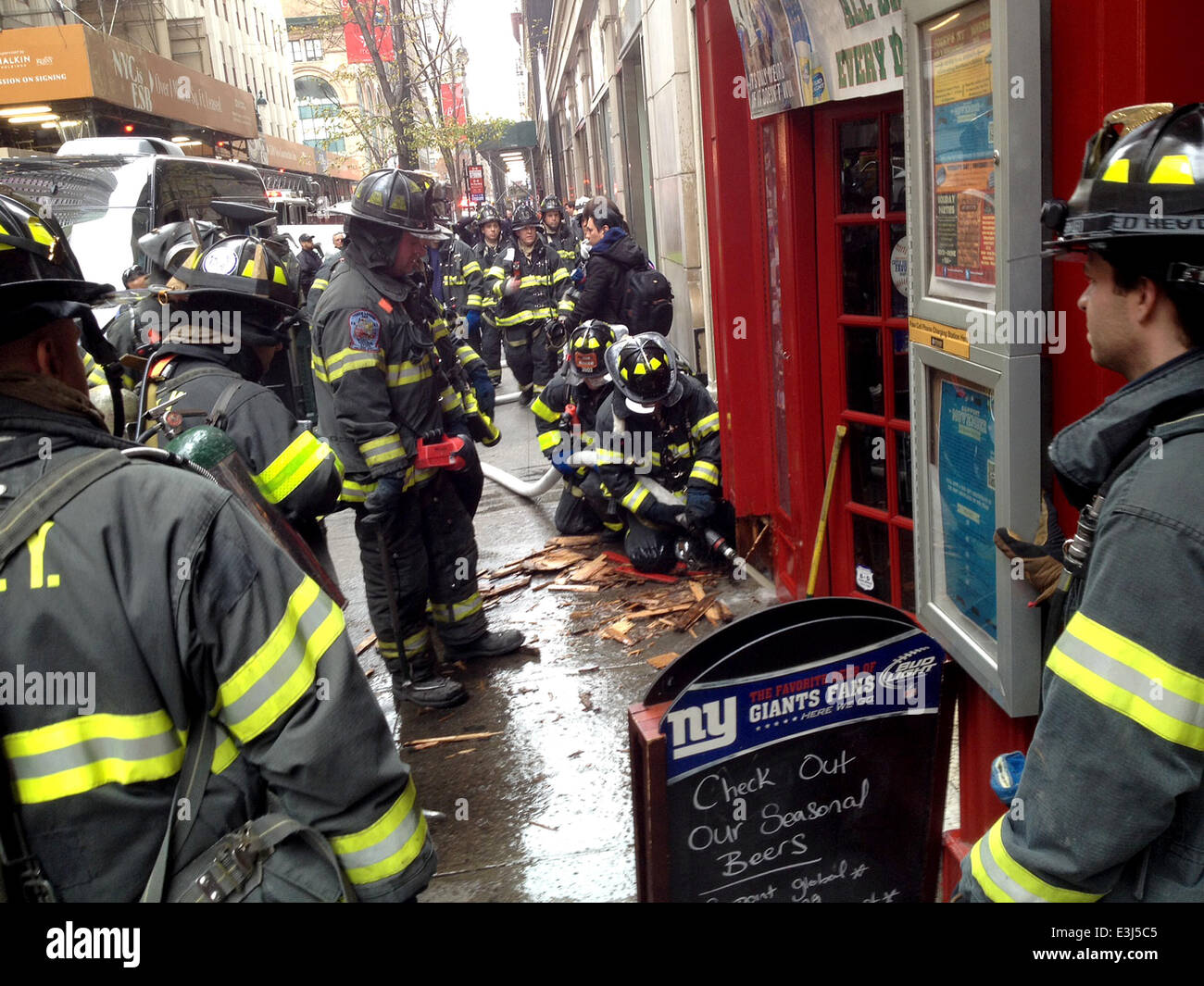Members of the FDNY respond to a call of a small fire that broke out at Foley's NY, the famed midtown pub and restaurant across the street from the Empire State Building  Where: New York City, United States When: 26 Nov 2013 Stock Photo