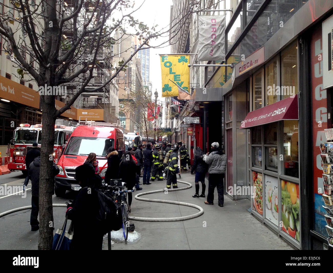 Members of the FDNY respond to a call of a small fire that broke out at Foley's NY, the famed midtown pub and restaurant across the street from the Empire State Building  Where: New York City, United States When: 26 Nov 2013 Stock Photo