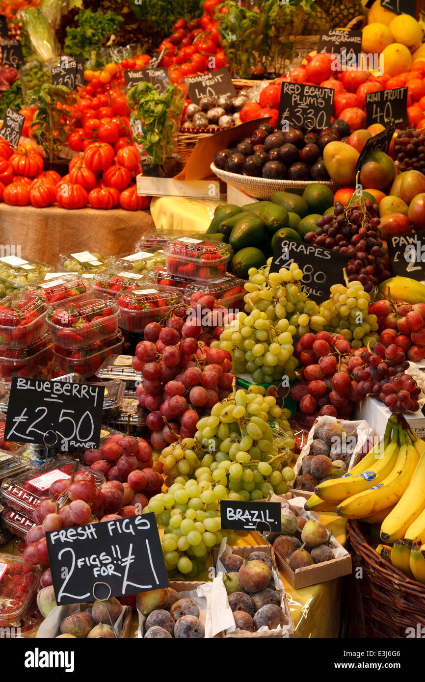 Red and green grapes and other fruit on market stall. Stock Photo