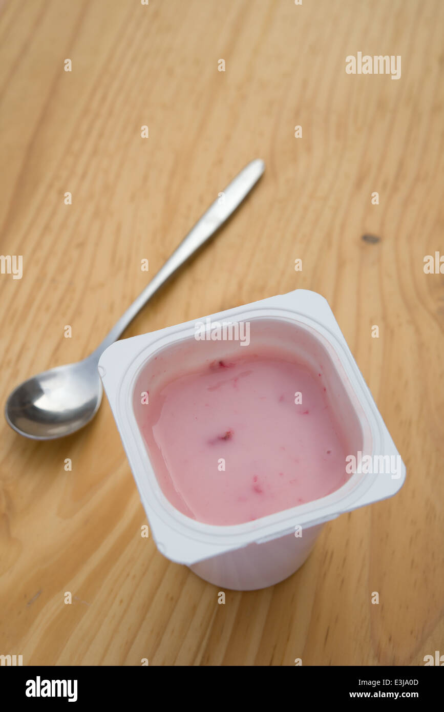 strawberry flavor yogurt on wooden table Stock Photo