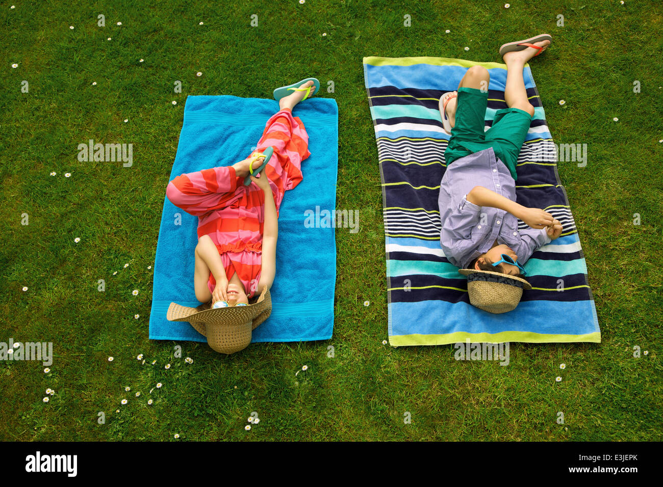 Boy Girl Sunbathing On Lawn High Resolution Stock Photography and