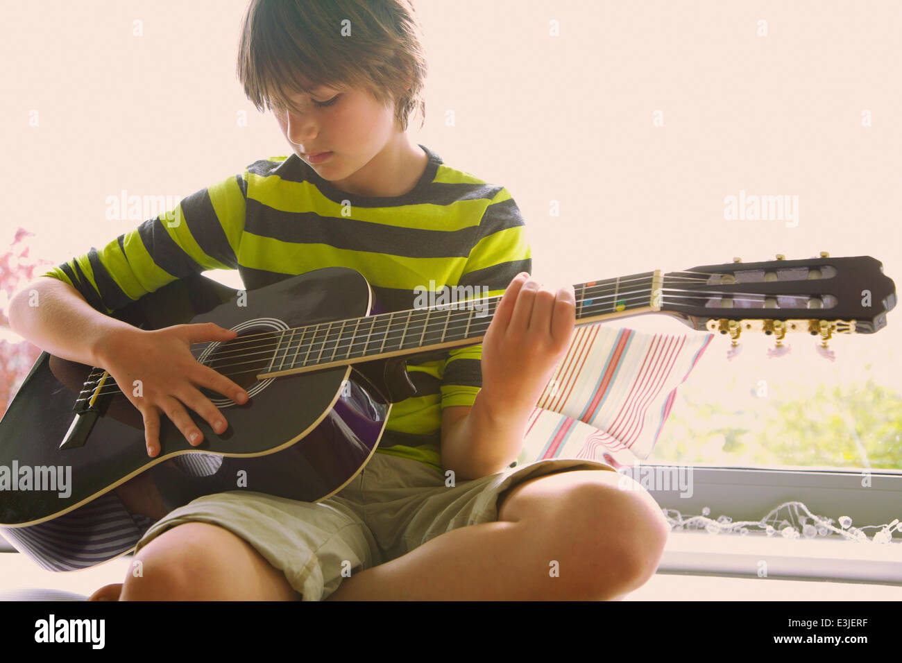 Boy playing guitar hires stock photography and images Alamy