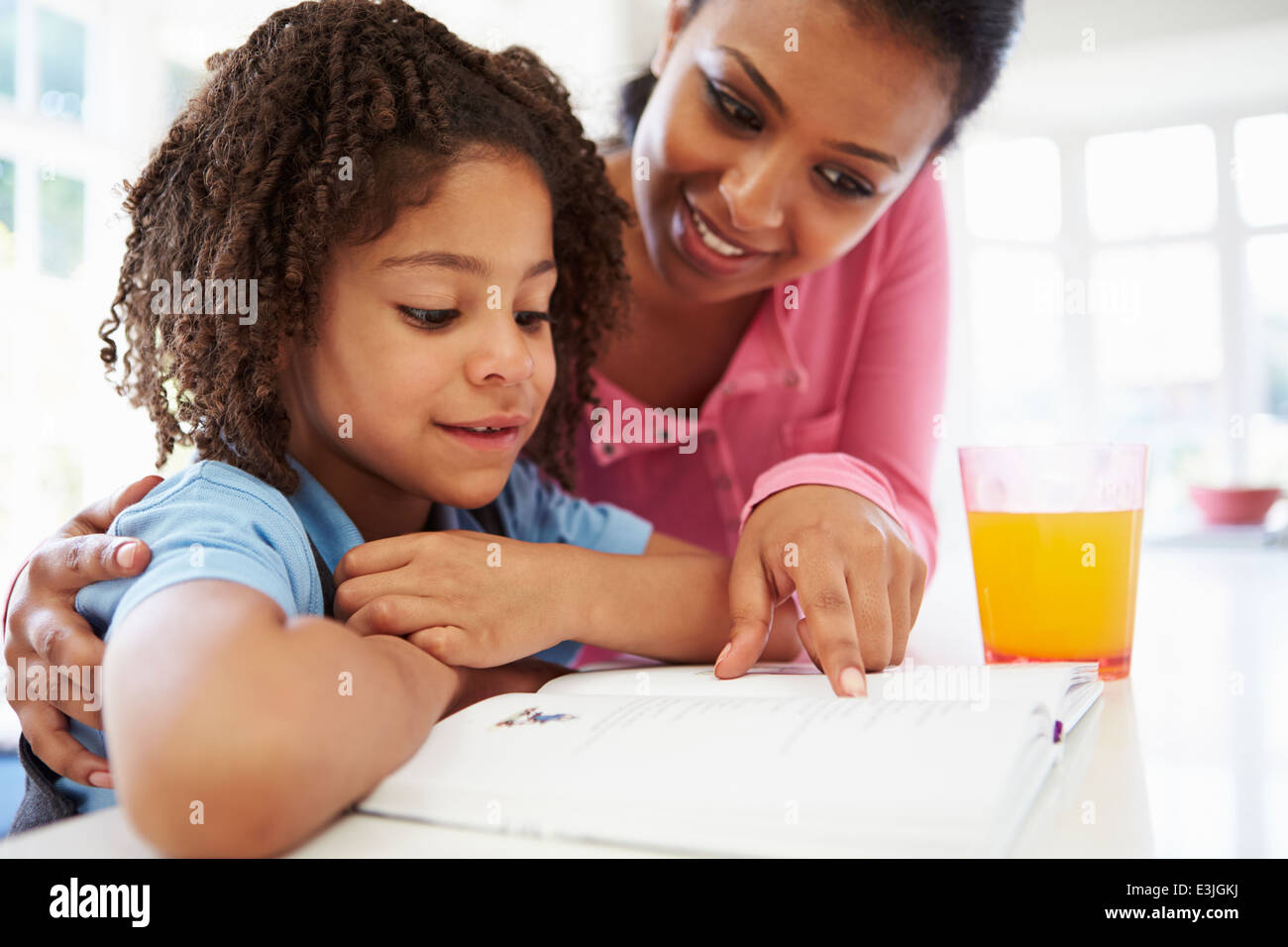 Mother Helping Daughter With Homework In Kitchen Stock Photo - Alamy