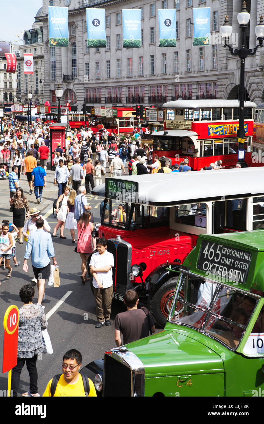 Regent Street, London, UK, 22nd June 2014. 2014 is the Year of the Bus: to celebrate this, Regent Street became traffic free and hosted iconic buses used in London from 1829 to present day.  Looking down Regent Street, crowds of people come to view the classic London buses. Bus festival. London tourism. Credit:  Alamy Live News Stock Photo