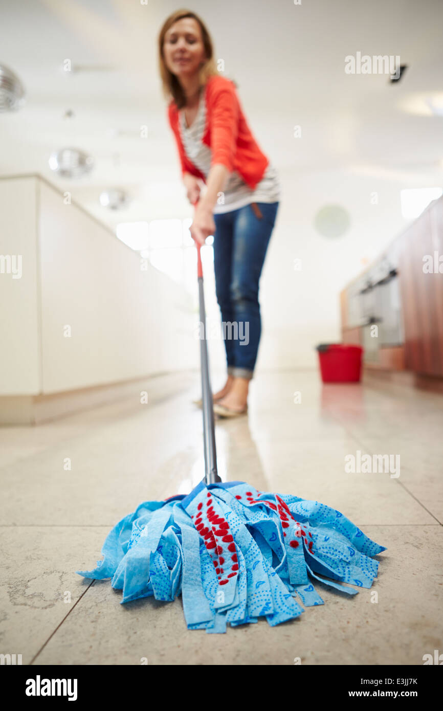 Woman Mopping Kitchen Floor Stock Photo