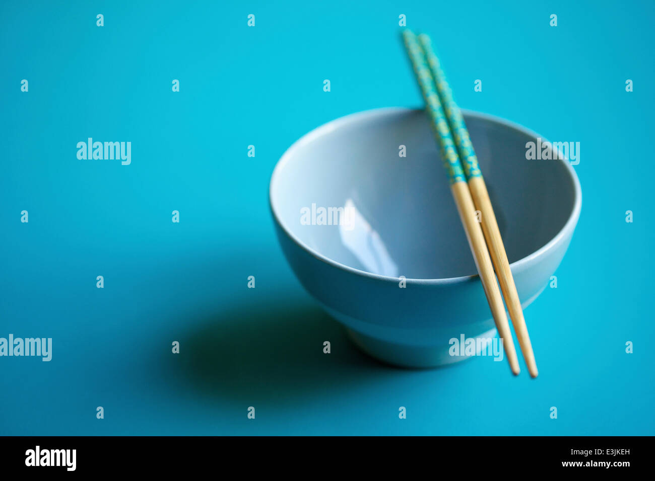 Empty Blue Bowl with Chopsticks Stock Photo