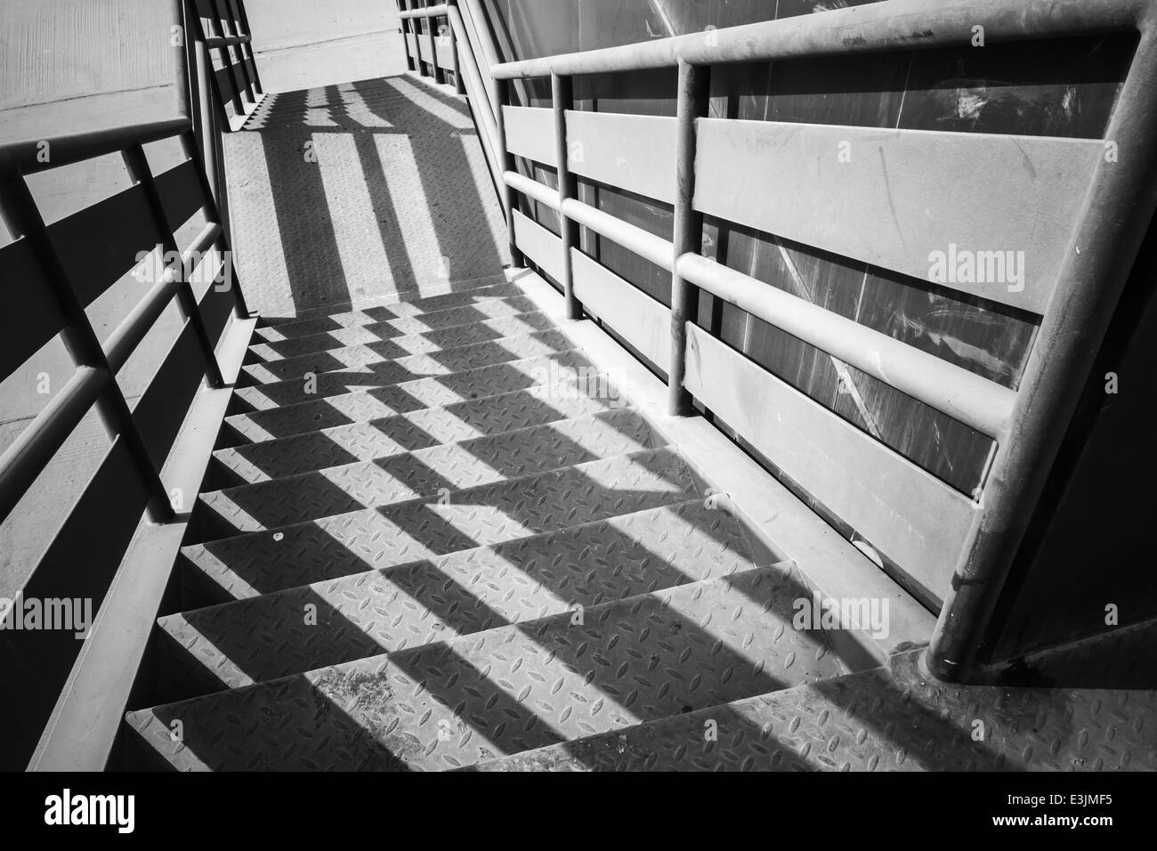 Industrial metal staircase perspective with shadows pattern Stock Photo