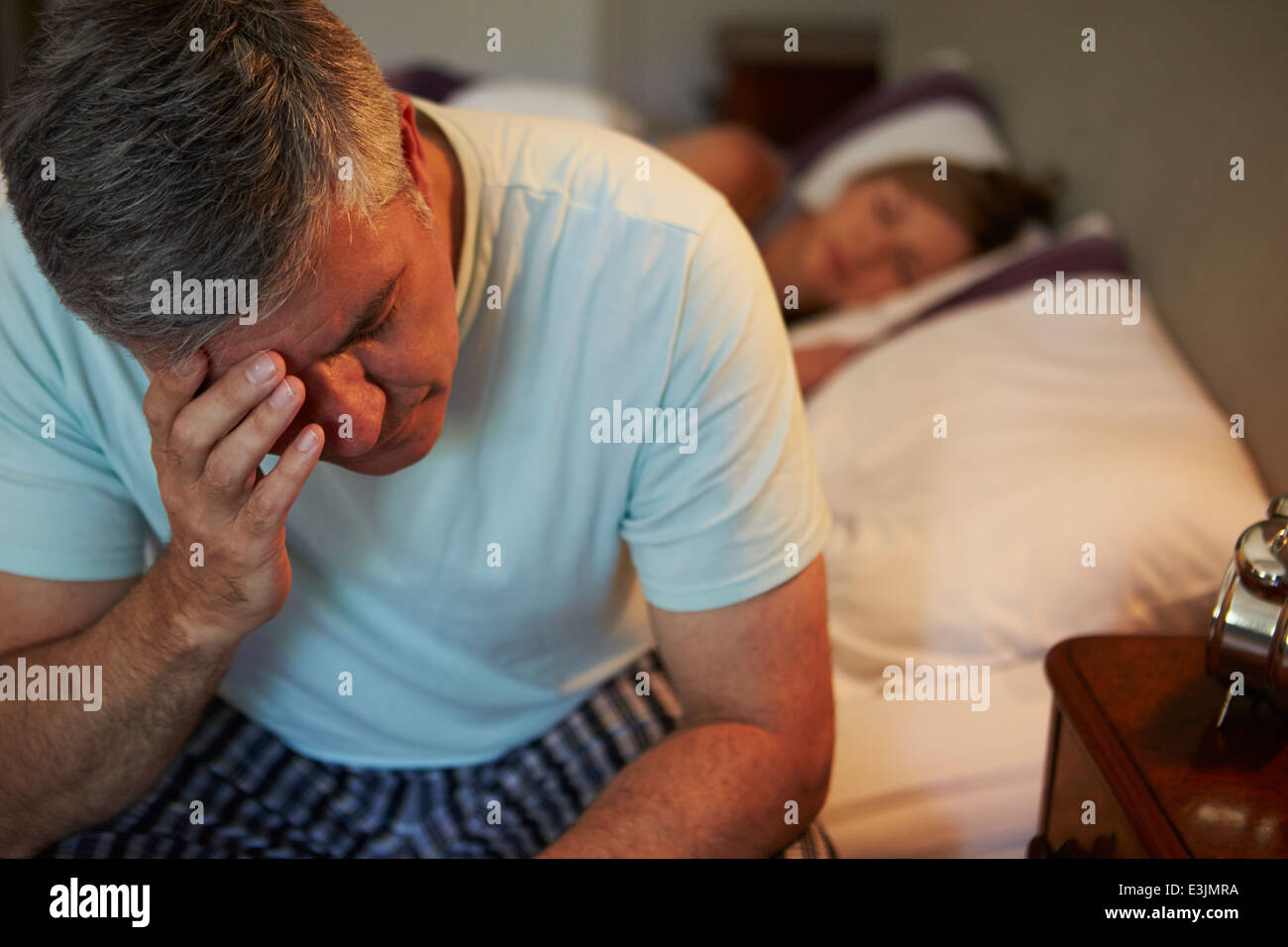 Man Awake In Bed Suffering With Insomnia Stock Photo