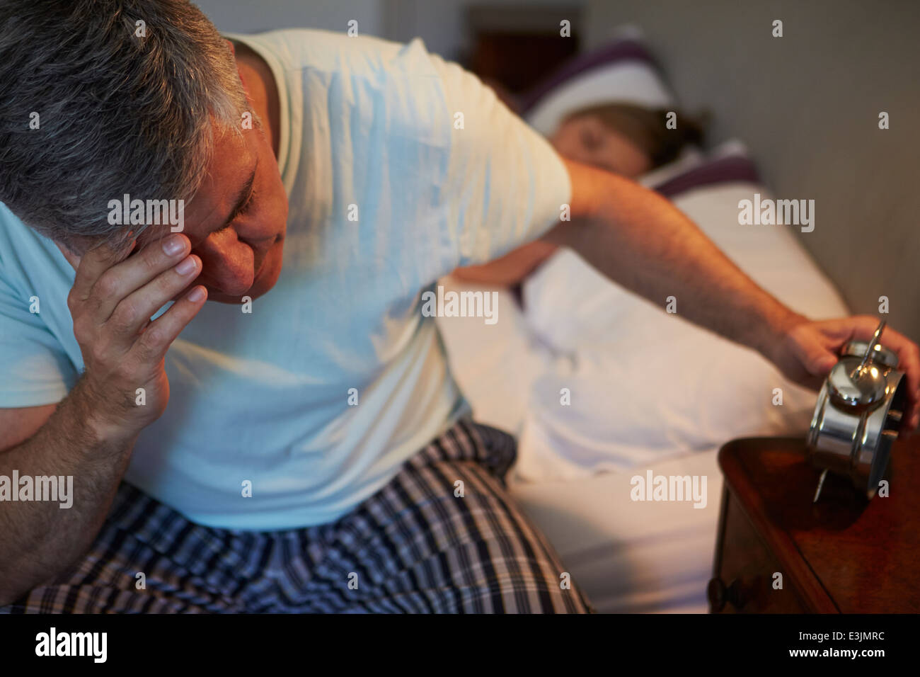 Man Awake In Bed Suffering With Insomnia Stock Photo