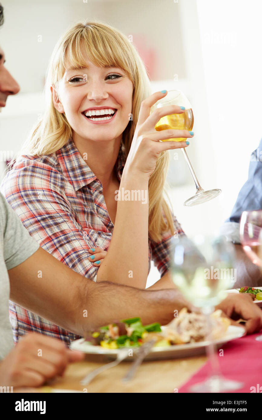 Young Woman Relaxing At Dinner Party Stock Photo