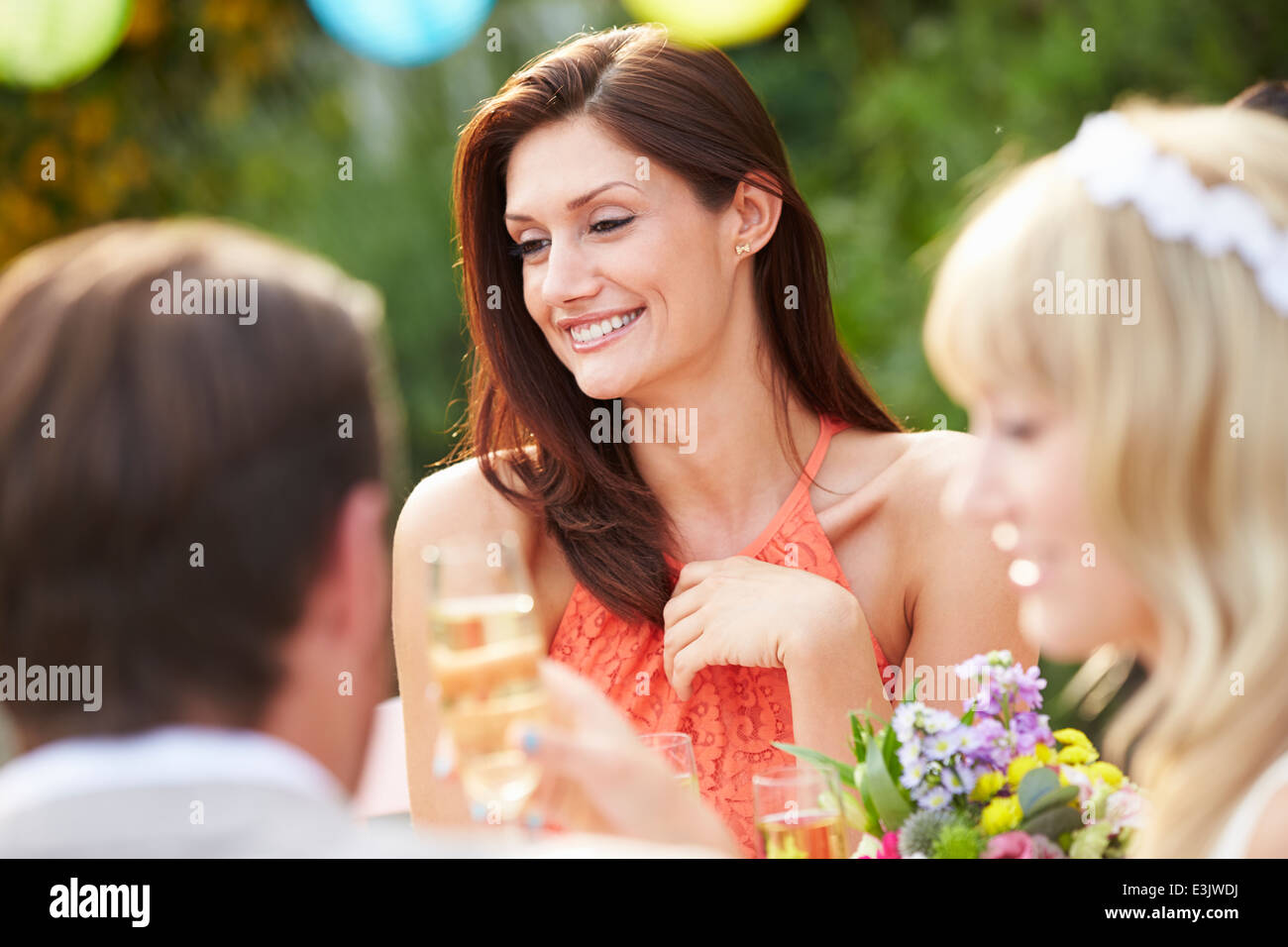 Female Guest At Wedding Reception Stock Photo