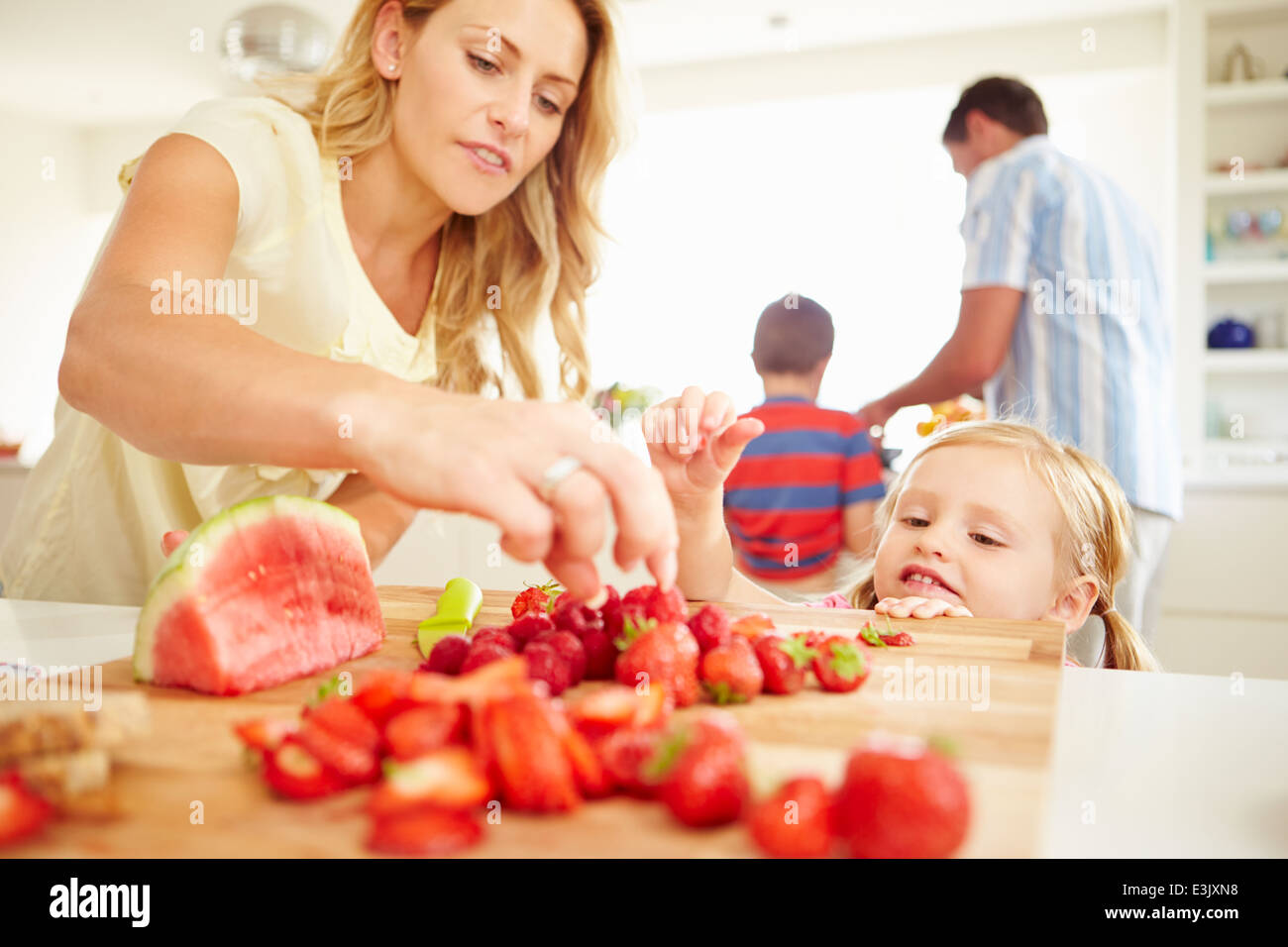 Daughter Helping Mother To Prepare Family Breakfast Stock Photo