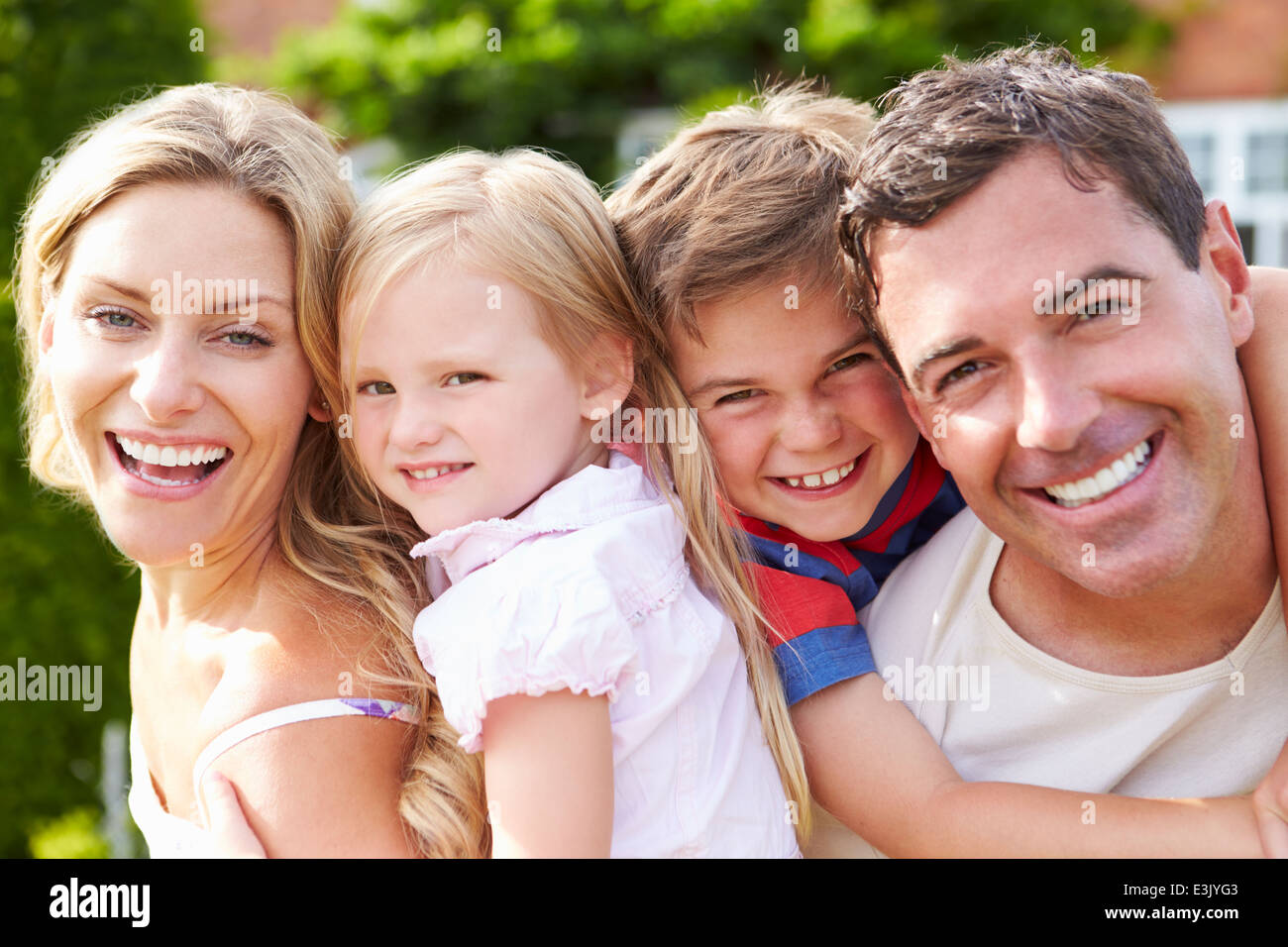 Portrait Of Happy Family In Garden Stock Photo