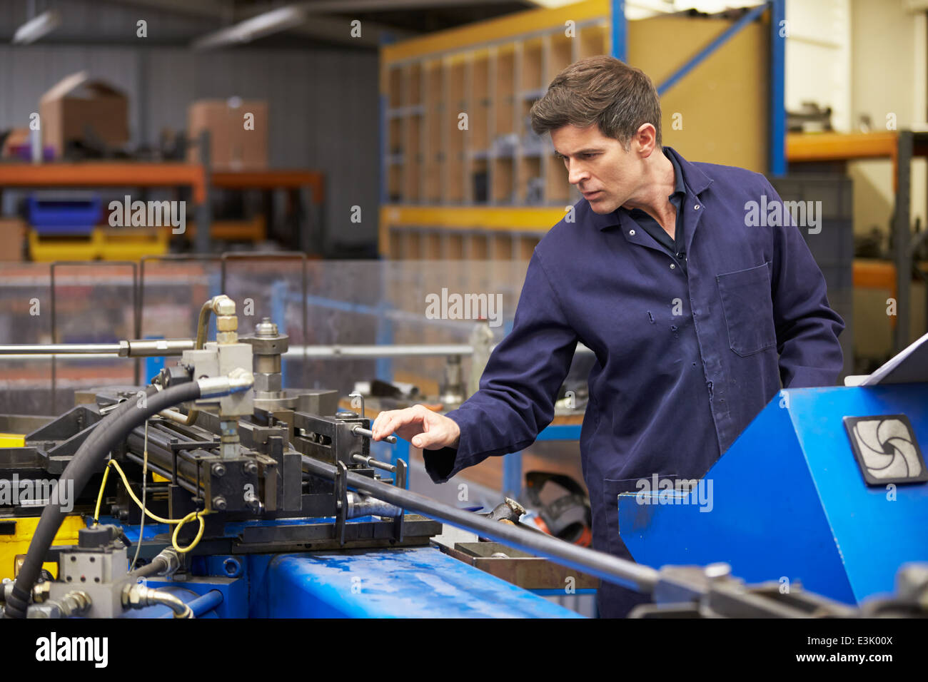 Factory Engineer Operating Hydraulic Tube Bender Stock Photo