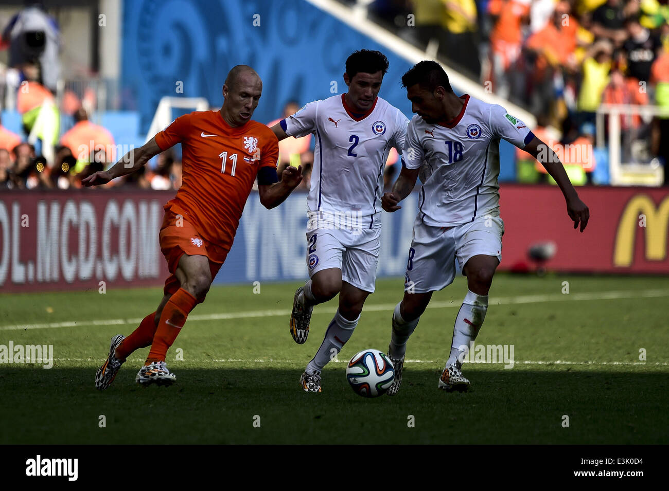 Sao Paolo, Brazil. 23rd June, 2014. Arjen Robben (11), Eugenio Mena (2) and Gonzalo Jara (18) at the match #36 of the 2014 World Cup, between Netherlands and Chile, this monday, June 23rd, in Sao Paulo, Brasil Credit:  Gustavo Basso/NurPhoto/ZUMAPRESS.com/Alamy Live News Stock Photo