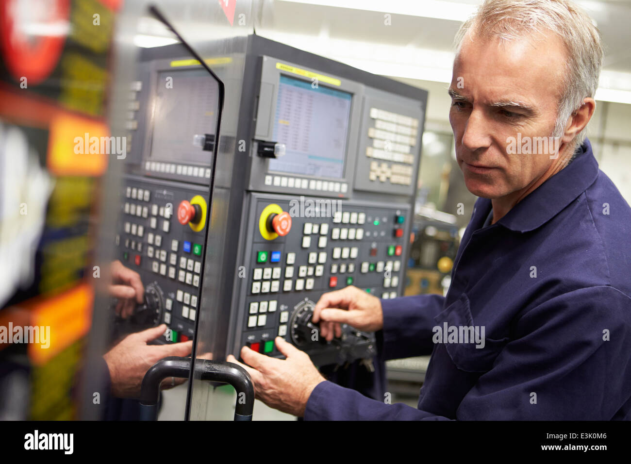 Engineer Operating Computer Controlled Lathe Stock Photo