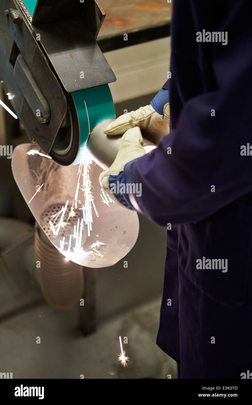 Close Up Of Engineer Using Grinding Machine In Factory Stock Photo