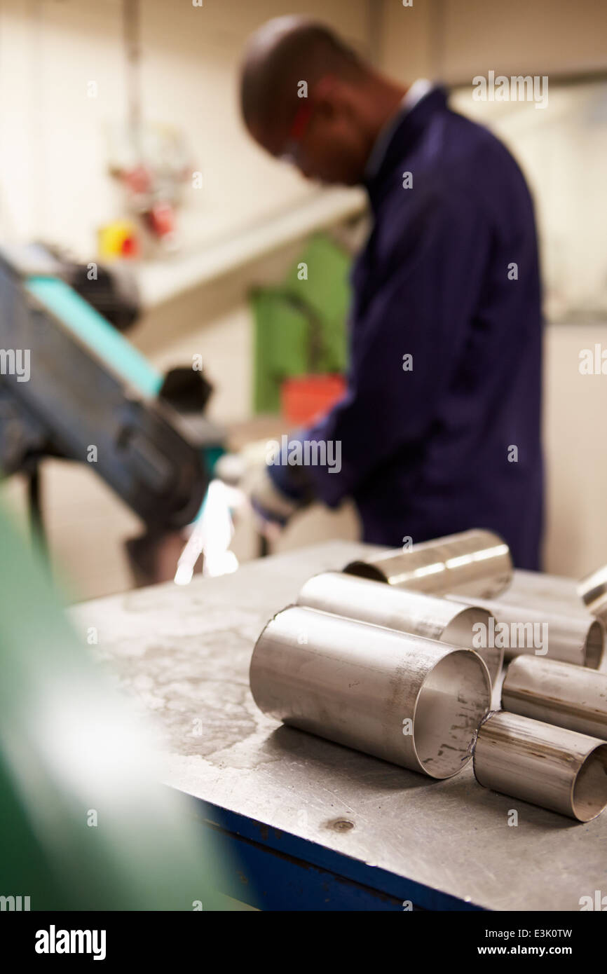 Engineer Using Grinding Machine In Factory Stock Photo