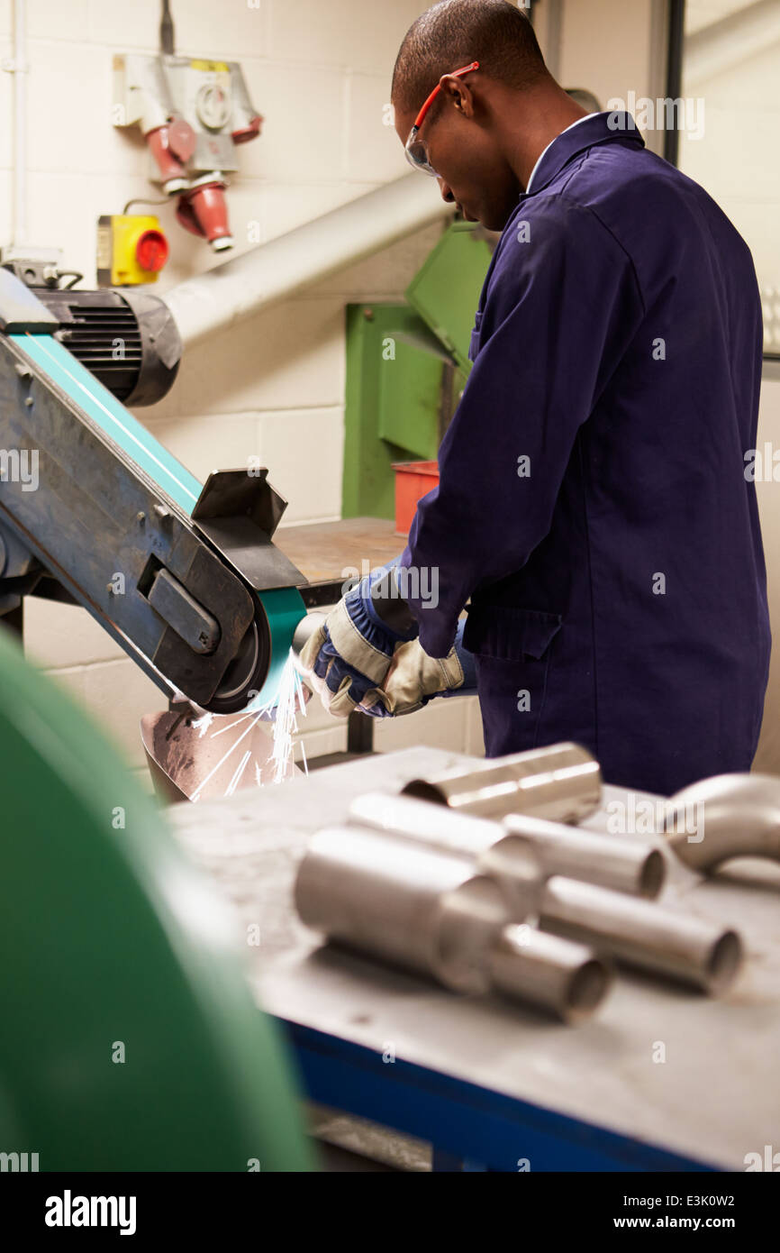 Engineer Using Grinding Machine In Factory Stock Photo