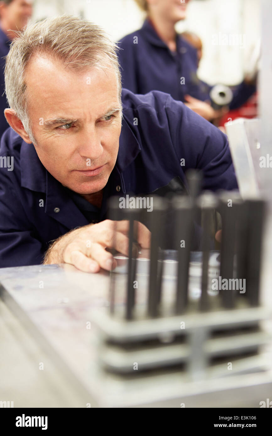 Engineer Studying Component In Workshop Stock Photo