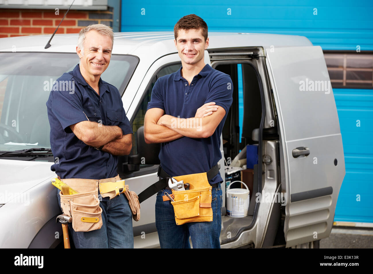 Workers In Family Business Standing Next To Van Stock Photo