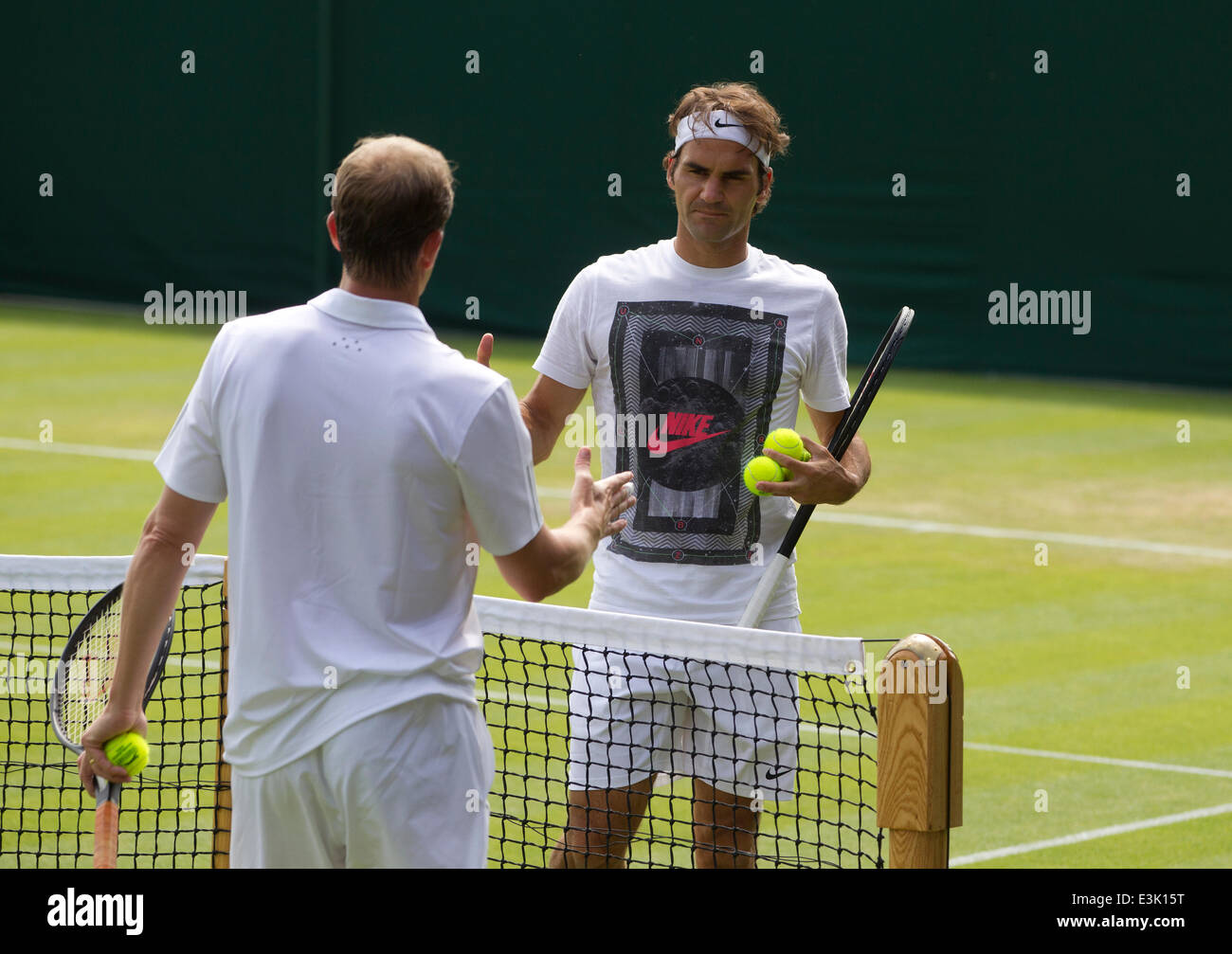 Wimbledon, London, UK. 24th June, 2014.  Picture shows Roger Federer (SUI) on day two of Wimbledon Tennis Campionships 2014 warming up with Swedish coach and former Champion Stefan Edberg. Credit:  Clickpics/Alamy Live News Stock Photo